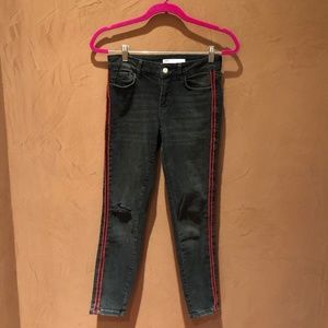 black ripped jeans with red stripe